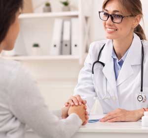 a doctor helping a patient at tms therapy now 