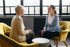 a doctor talking a young woman about Evidence Based Therapy Program