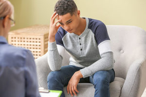 a young man talking to his doctor during Interpersonal Therapy