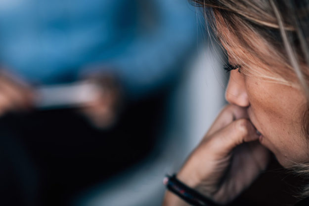 woman biting her nails at therapy for Depression Treatment During a National Crisis